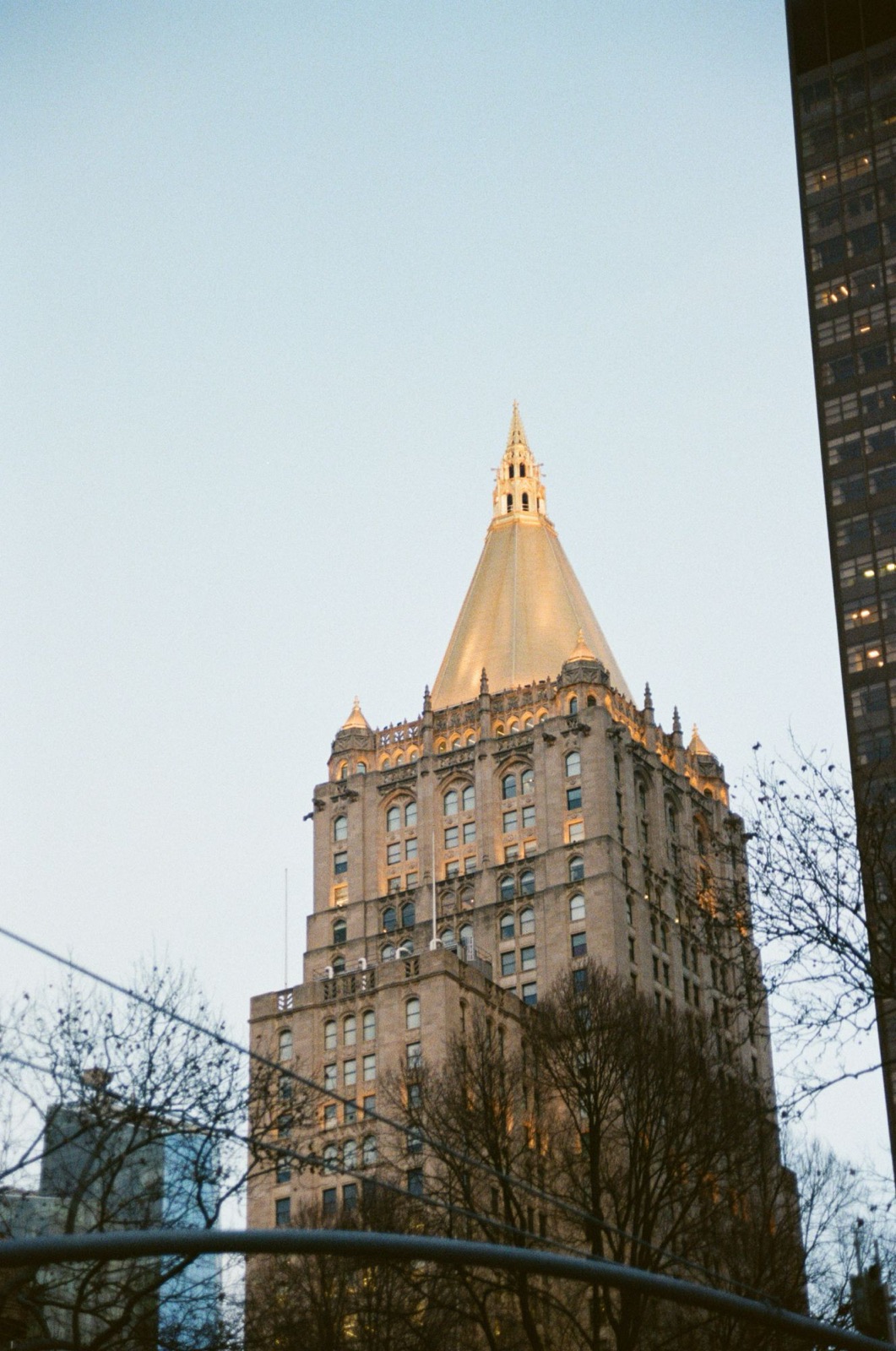 The gold-topped New York Life building at dusk, on film