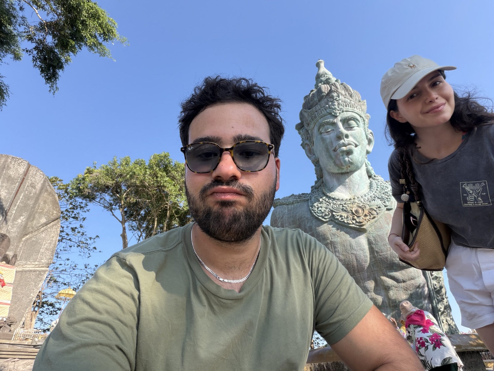 By a statue in Bali